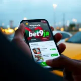 Mobile phone displaying Bet9ja app with Paystack payment gateway